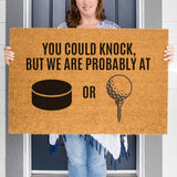 a woman holding a sign that says you could knock, but we are probably at