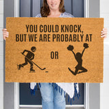 a woman holding a sign that says you could knock but we are probably at or